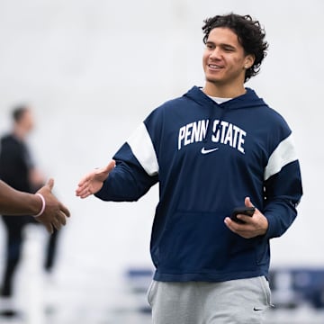Penn State linebacker Tony Rojas, right, greets former Nittany Lion Kobe King during Penn State's Pro Day in Holuba Hall in March.