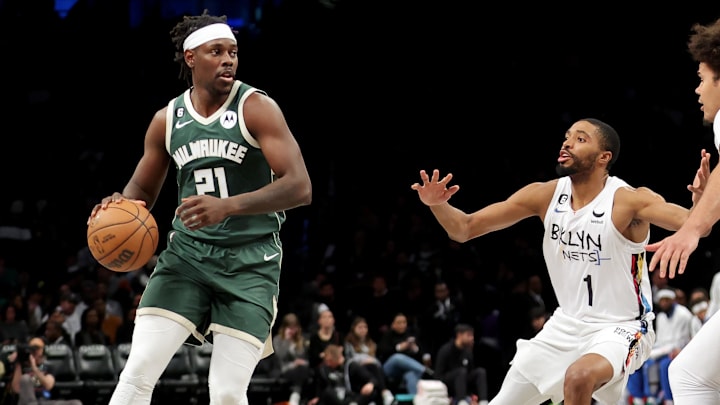 Feb 28, 2023; Brooklyn, New York, USA; Milwaukee Bucks guard Jrue Holiday (21) controls the ball against Brooklyn Nets forwards Mikal Bridges (1) and Cameron Johnson (2) during the third quarter at Barclays Center. Mandatory Credit: Brad Penner-Imagn Images