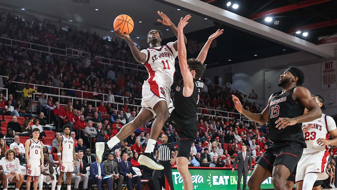 Dec 23, 2025; Queens, New York, USA;  St. John's basketball guard Ian Jackson (11) drives past Harvard Crimson guard Ben Eisendrath (5) in the second half at Carnesecca Arena.