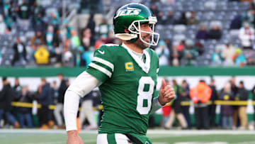 Jan 5, 2025; East Rutherford, New Jersey, USA; New York Jets quarterback Aaron Rodgers (8) runs onto the field for pregame warmups for their game against the Miami Dolphins at MetLife Stadium.
