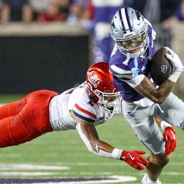 Sep 13, 2024; Manhattan, Kansas, USA; Kansas State Wildcats wide receiver Jayce Brown (1) runs away from Arizona Wildcats defensive back Treydan Stukes (2) during the fourth quarter at Bill Snyder Family Football Stadium. 