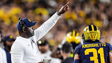 Michigan linebackers coach Brian Jean-Mary signals players before a play against New Mexico during the first half at Michigan Stadium in Ann Arbor on Saturday, August 30, 2025.