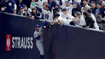 Oct 29, 2024; New York, New York, USA; Los Angeles Dodgers shortstop Mookie Betts (50) makes a catch in foul territory as a New York Yankees fan interferes during the first inning in game four of the 2024 MLB World Series at Yankee Stadium. Mandatory Credit: Brad Penner-Imagn Images