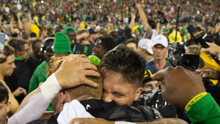 Oregon quarterback Dillon Gabriel celebrates with Terrance Ferguson and Duck fans after defeating Ohio State 32-31 at Autzen Stadium Saturday, Oct. 12, 2024.