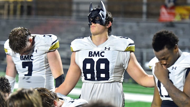 Bishop Moore's Jake Kreul (88) wears his batman mask as he and teammates gather after Friday night's 37 to 35 victory over the Riverside Generals. Orlando  s Bishop Moore High School traveled to Jacksonville  s Riverside High School for the Class 3M football Playoffs Friday, November 17, 2023. The Riverside Generals trailed 22 to 13 at the half and battled back in the second half but fell short, ending their season with a 37 to 35 loss to the Bishop Moore Hornets.