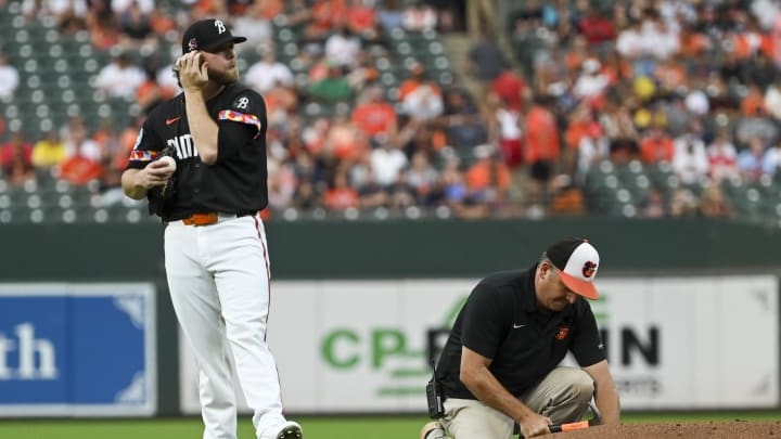 Aug 16, 2024; Baltimore, Maryland, USA;  Baltimore Orioles starting pitcher Corbin Burnes (39) wait for the the member of the ground crew to places equipment of the field during the first inning against the Boston Red Sox at Oriole Park at Camden Yards.