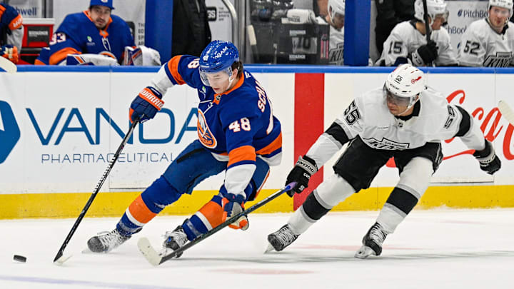 Mar 13, 2026; Elmont, New York, USA;  New York Islanders defenseman Matthew Schaefer (48) skates with the puck defended by Los Angeles Kings right wing Quinton Byfield (55) during the first period at UBS Arena. Mandatory Credit: Dennis Schneidler-Imagn Images