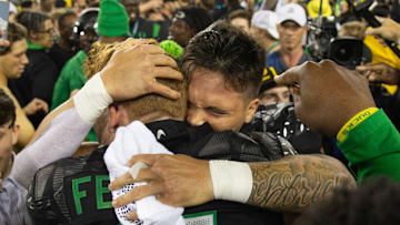 Oregon quarterback Dillon Gabriel celebrates with Terrance Ferguson and Duck fans after defeating Ohio State 32-31 at Autzen Stadium Saturday, Oct. 12, 2024.