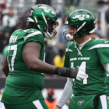 Dec 24, 2023; East Rutherford, New Jersey, USA; New York Jets quarterback Trevor Siemian (14) and offensive tackle Carter Warren (67) on the field before the game against the Washington Commanders at MetLife Stadium. Mandatory Credit: Vincent Carchietta-Imagn Images