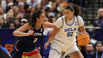 Apr 4, 2025; Tampa, FL, USA;  UCLA Bruins center Lauren Betts (51) dribbles against Connecticut Huskies center Jana El Alfy (8) during the third quarter in a semifinal of the women's 2025 NCAA tournament at Amalie Arena. Mandatory Credit: Nathan Ray Seebeck-Imagn Images
