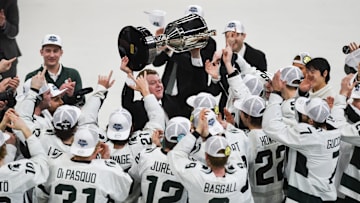 MSU hockey coach Adam Nightingale hoists up the Big Ten Championship trophy after the Spartans beat U-M 5-4 in an overtime thriller, Saturday, March 23, 2024, during the first period of the Big Ten hockey championship at Munn Ice Arena in East Lansing.