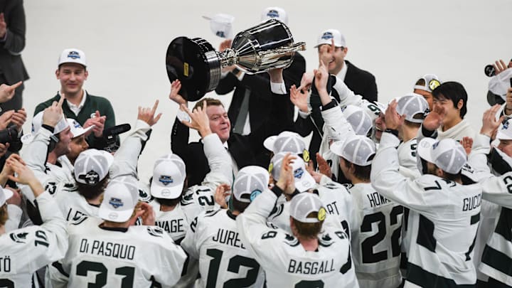 MSU hockey coach Adam Nightingale hoists up the Big Ten Championship trophy after the Spartans beat U-M 5-4 in an overtime thriller, Saturday, March 23, 2024, during the first period of the Big Ten hockey championship at Munn Ice Arena in East Lansing.