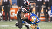 Jun 13, 2024; Ottawa, Ontario, CAN; Ottawa REDBLACKS running back Devonte Dedmon (17) is tackled by Winnipeg Blue Bombers fullback Bailey Feltmate in the first half at TD Place. Mandatory Credit: Marc DesRosiers-Imagn Images