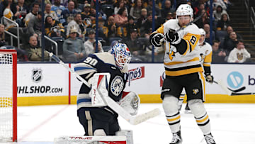 Nov 15, 2024; Columbus, Ohio, USA; Pittsburgh Penguins left wing Michael Bunting (8) tips the puck over Columbus Blue Jackets goalie Elvis Merzlikins (90) during the third period at Nationwide Arena. Mandatory Credit: Russell LaBounty-Imagn Images
