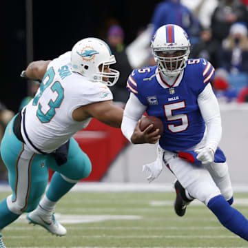 Dec 17, 2017; Orchard Park, NY, USA; Miami Dolphins defensive tackle Ndamukong Suh (93) dives to try and tackle Buffalo Bills quarterback Tyrod Taylor (5) as he runs the ball during the second half at New Era Field. Buffalo beats Miami 24 to 16. 