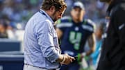Oct 6, 2024; Seattle, Washington, USA; Seattle Seahawks general manager John Schneider looks at his phone during the fourth quarter against the New York Giants at Lumen Field. 