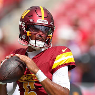 Sep 8, 2024; Tampa, Florida, USA; Washington Commanders quarterback Jayden Daniels (5) warms up before a game against the Tampa Bay Buccaneers at Raymond James Stadium. Mandatory Credit: Nathan Ray Seebeck-Imagn Images