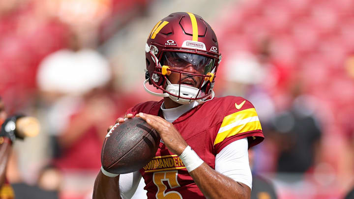 Sep 8, 2024; Tampa, Florida, USA; Washington Commanders quarterback Jayden Daniels (5) warms up before a game against the Tampa Bay Buccaneers at Raymond James Stadium. Mandatory Credit: Nathan Ray Seebeck-Imagn Images