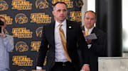 Ben McCollum, Iowa's new head men's basketball coach, walks to the podium during his introductory press conference Tuesday, March 25, 2025 at Carver-Hawkeye Arena in Iowa City, Iowa.