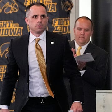 Ben McCollum, Iowa's new head men's basketball coach, walks to the podium during his introductory press conference Tuesday, March 25, 2025 at Carver-Hawkeye Arena in Iowa City, Iowa.