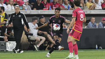 Inter Miami defender Ian Fray (24) kicks the ball past St. Louis midfielder Jared Stroud (8) under the watchful eyes of new Miami coach Tata Martino.