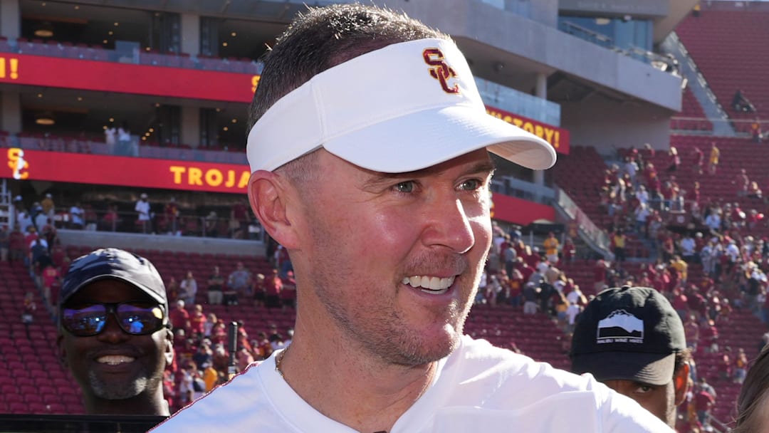 Sep 28, 2024; Los Angeles, California, USA; Southern California Trojans head coach Lincoln Riley visits with daughters Stella Riley (left) and Sloan Riley after the game against the Wisconsin Badgers at  United Airlines Field at Los Angeles Memorial Coliseum. Mandatory Credit: Kirby Lee-Imagn Images