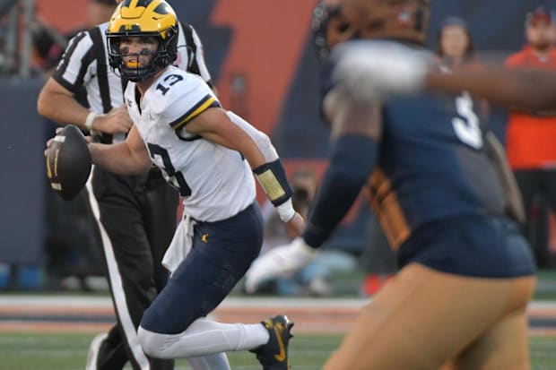 Wolverines quarterback Jack Tuttle runs with the ball.