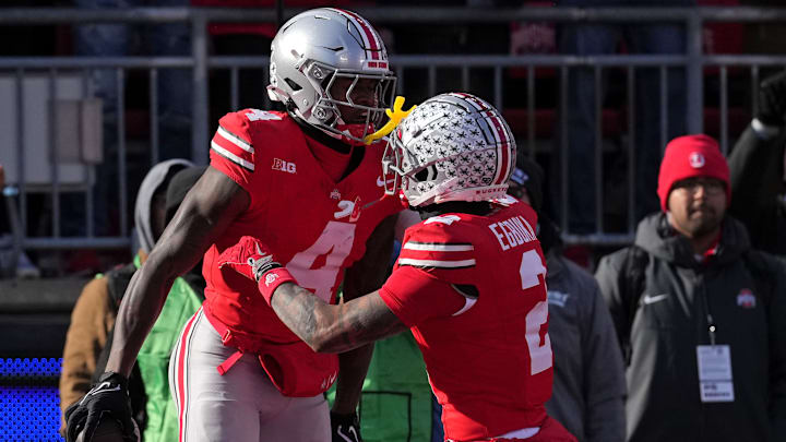 Jeremiah Smith #4 of the Ohio State Buckeyes celebrates after his touchdown reception against the Michigan Wolverines with Emeka Egbuka #2 during the second quarter at Ohio Stadium on November 30, 2024 in Columbus, Ohio.