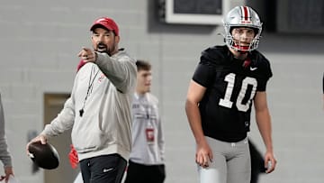Ohio State Buckeyes head coach Ryan Day works with quarterbacks Julian Sayin (10) and Tavien St. Clair (9) during spring football practice at the Woody Hayes Athletic Center in Columbus on March 19, 2025.