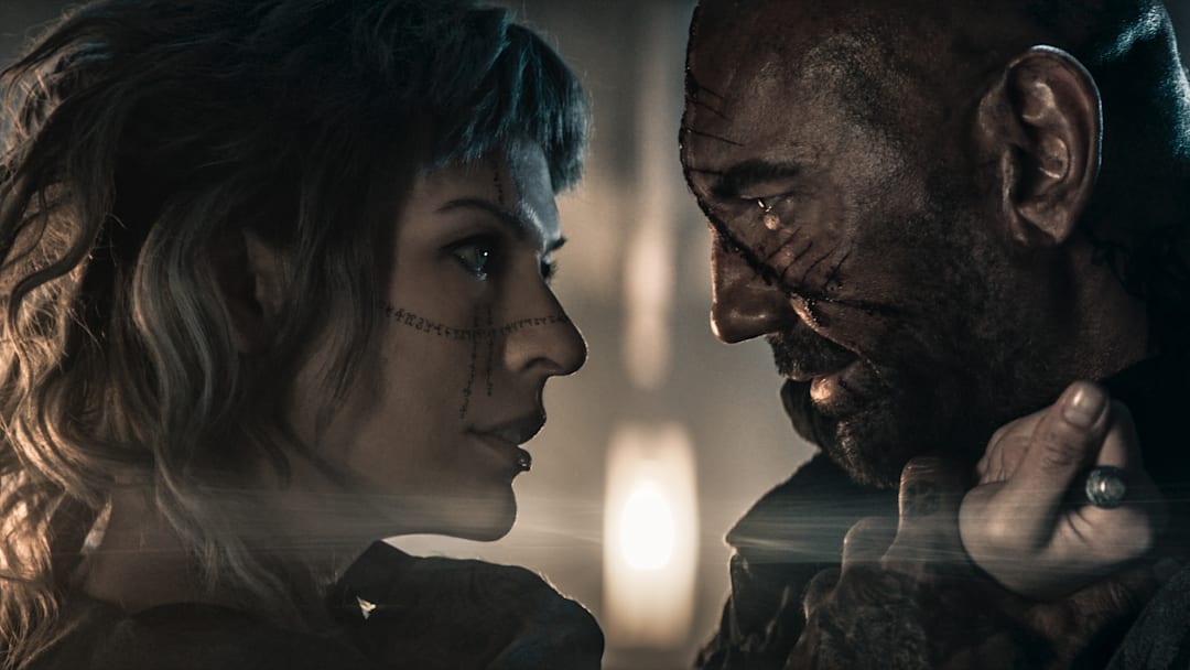 Gray Alys (Milla Jovovich) and Boyce (Dave Bautista) in In the Lost Lands. Image: Vertical.