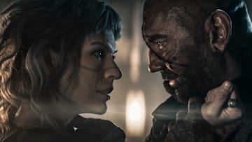 Gray Alys (Milla Jovovich) and Boyce (Dave Bautista) in In the Lost Lands.