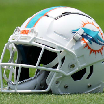 May 17, 2022; Miami Gardens, FL, USA; A general view of a Miami Dolphins helmet on the grass during OTA practice at Baptist Health Training Complex. Mandatory Credit: Jasen Vinlove-Imagn Images