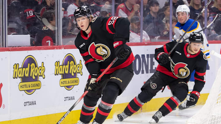 Sep 26, 2024; Ottawa, Ontario, CAN; Ottawa Senators defenseman Carter Yakemchuk (58) controls the puck in the second period against the Buffalo Sabres at the Canadian Tire Centre. Mandatory Credit: Marc DesRosiers-Imagn Images