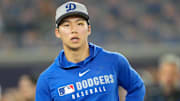 Los Angeles Dodgers pitcher Yoshinobu Yamamoto (18) looks on during batting practice prior to game one of the 2025 MLB World Series against the Toronto Blue Jays at Rogers Centre.