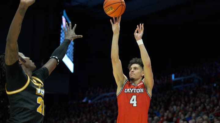 Mar 8, 2024; Dayton, Ohio, USA;  Dayton Flyers guard Koby Brea (4) shoots the ball against Virginia Commonwealth Rams forward Christian Fermin (21) during the second half of the game at University of Dayton Arena. Mandatory Credit: Matt Lunsford-USA TODAY Sports