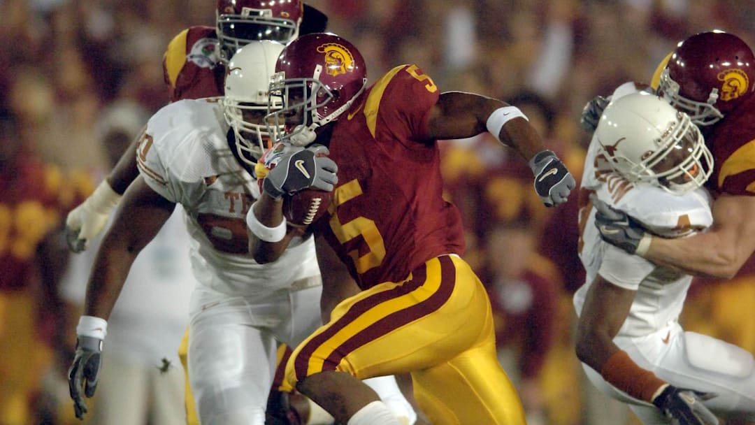 Jan 4, 2006; Pasadena, CA, USA; Southern California Trojans tailback (5) Reggie Bush runs down the middle during the 1st quarter of the Rose Bowl Game against the Texas Longhorns at the Rose Bowl in Pasadena, California. Mandatory Credit: Mark J. Rebilas-Imagn Images Copyright © 2006 Mark J. Rebilas