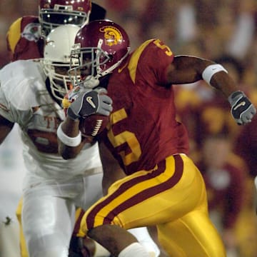 Jan 4, 2006; Pasadena, CA, USA; Southern California Trojans tailback (5) Reggie Bush runs down the middle during the 1st quarter of the Rose Bowl Game against the Texas Longhorns at the Rose Bowl in Pasadena, California. Mandatory Credit: Mark J. Rebilas-Imagn Images Copyright © 2006 Mark J. Rebilas