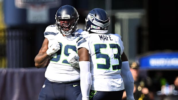 Seattle Seahawks defensive end Leonard Williams (99) reacts with linebacker Boye Mafe (53).