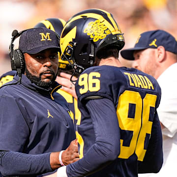 Michigan head coach Sherrone Moore shakes hands with place kicker Dominic Zvada (96) after an extra point against Washington during the second half at Michigan Stadium in Ann Arbor on Saturday, Oct. 18, 2025.