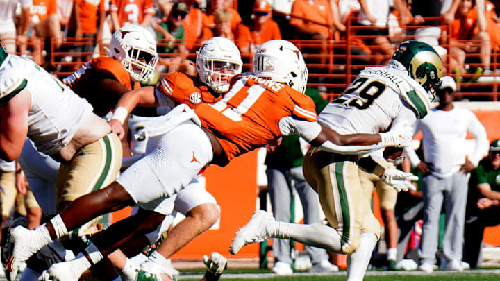 Aug 31, 2024; Austin, Texas, USA; Colorado State Rams running back Justin Marshall (29) is tackled by Texas Longhorns defensive back Colin Simmons (11) during the first half at Darrell K Royal-Texas Memorial Stadium. Mandatory Credit: Aaron Meullion-Imagn Images