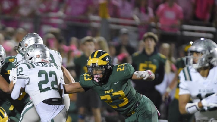 Marco Jones (23), the Bay Area's top recruit from San Ramon Valley, is about to pull down De La Salle's Derrick Blanche Jr., the Bay's No. 43 player.