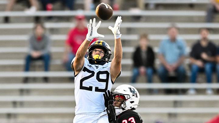 Oct 12, 2023; Houston, Texas, USA; West Virginia Mountaineers wide receiver Preston Fox (29) receives a pass as Houston Cougars defensive back Isaiah Hamilton (23) defends in the first quarter  at TDECU Stadium. Mandatory Credit: Maria Lysaker-Imagn Images
