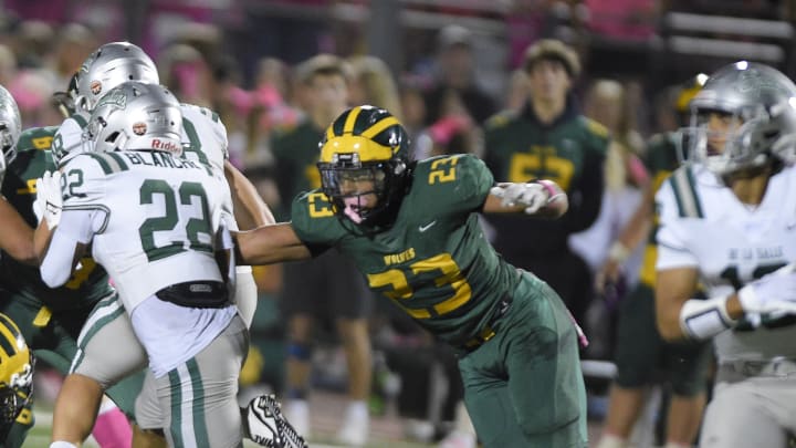 Marco Jones (23), the Bay Area's top recruit from San Ramon Valley, is about to pull down De La Salle's Derrick Blanche Jr., the Bay's No. 43 player