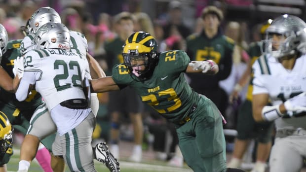 Marco Jones (23), the Bay Area's top recruit from San Ramon Valley, is about to pull down De La Salle's Derrick Blanche Jr., the Bay's No. 43 player.