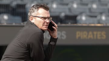 Jun 5, 2024; Pittsburgh, Pennsylvania, USA;  Pittsburgh Pirates general manager Ben Cherington speaks on the phone in the dugout before the Pirates host the Los Angeles Dodgers at PNC Park. Mandatory Credit: Charles LeClaire-Imagn Images