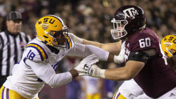 Nov 26, 2022; College Station, Texas, USA; Texas A&M Aggies offensive lineman Trey Zuhn III (60) blocks LSU Tigers defensive end BJ Ojulari (18) during the first quarter at Kyle Field. Mandatory Credit: Jerome Miron-USA TODAY Sports