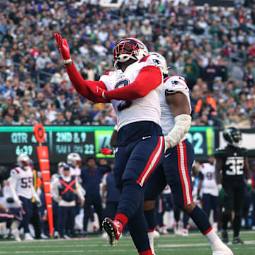 Oct 30, 2022; East Rutherford, New Jersey, USA; New England Patriots defensive end Lawrence Guy (93) celebrates a sack against the New York Jets with linebacker Matthew Judon (9) during the fourth quarter at MetLife Stadium. Mandatory Credit: Brad Penner-Imagn Images