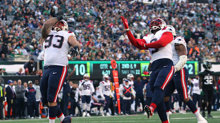 Oct 30, 2022; East Rutherford, New Jersey, USA; New England Patriots defensive end Lawrence Guy (93) celebrates a sack against the New York Jets with linebacker Matthew Judon (9) during the fourth quarter at MetLife Stadium. Mandatory Credit: Brad Penner-Imagn Images