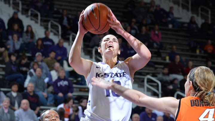 Jan 8, 2014; Manhattan, KS, USA; Kansas State Wildcats guard Leticia Romero (10) drives to the basket past Oklahoma State Cowgirls guard Roshunda Johnson (00) during the second half at Fred Bramlage Coliseum. Oklahoma State won 58-51. Mandatory Credit: Peter G. Aiken-USA TODAY Sports