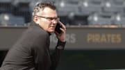 Jun 5, 2024; Pittsburgh, Pennsylvania, USA;  Pittsburgh Pirates general manager Ben Cherington speaks on the phone in the dugout before the Pirates host the Los Angeles Dodgers at PNC Park. Mandatory Credit: Charles LeClaire-Imagn Images